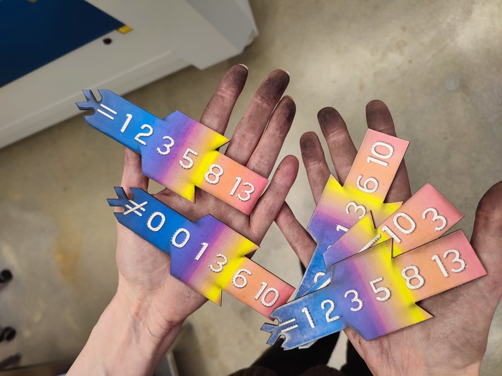 components in my hands, my fingers a black with soot