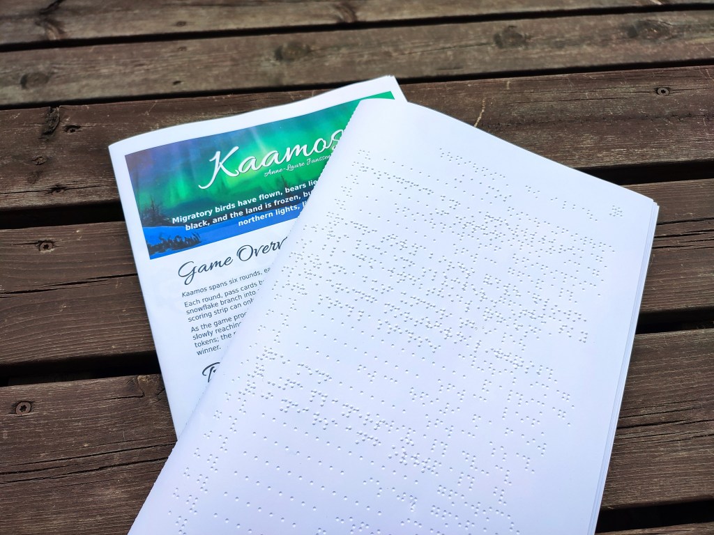 a printed rulebook and a rulebook embossed in braille.