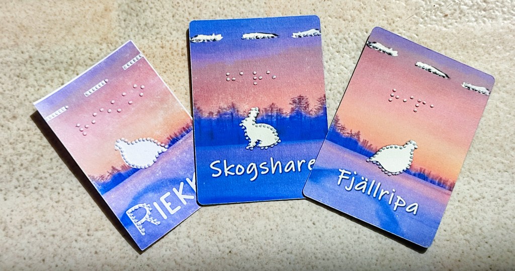 3 playing cards: one showing a ptarmigan turned to the right, one with a hare to the right, and one with a ptarmigan to the left
